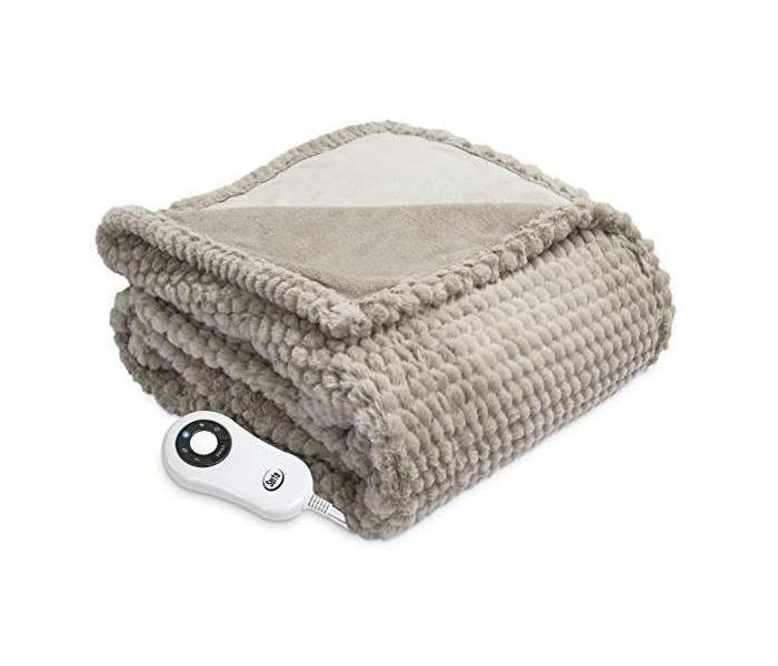 Heated blanket folded with remote 