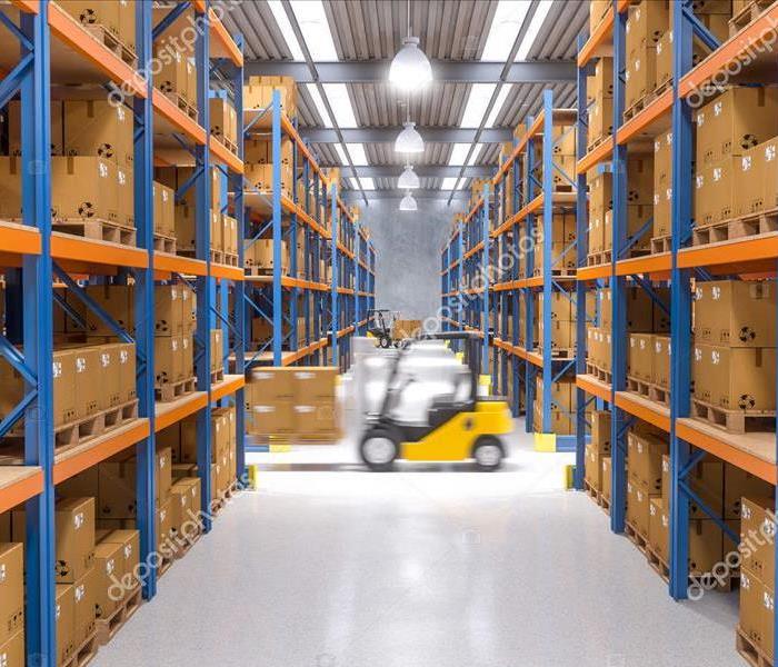 warehouse shelving and forklift driving by 